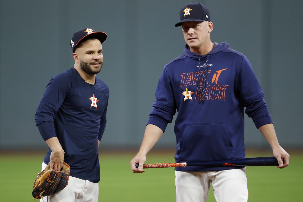 HOUSTON, TEXAS - OCTOBER 29:  Jose Altuve #27 and AJ Hinch #14 of the Houston Astros looks on during batting practice prior to Game Six of the 2019 World Series against the Washington Nationals at Minute Maid Park on October 29, 2019 in Houston, Texas. (Photo by Tim Warner/Getty Images)