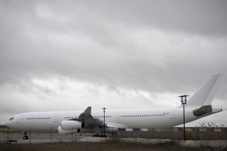 The plane reported to carry some 300 Indian citizens parks at the Vatry airport, eastern France, Saturday, Dec. 23, 2023 in Vatry. About 300 Indian citizens heading to Central America were sequestered in a French airport for a third day Saturday because of an investigation into suspected human trafficking, authorities said. The 15 crew members of the Legend Airlines charter flight en route from United Arab Emirates to Nicaragua were questioned and released, according to a lawyer for the small Romania-based airline. (AP Photo/Christophe Ena)