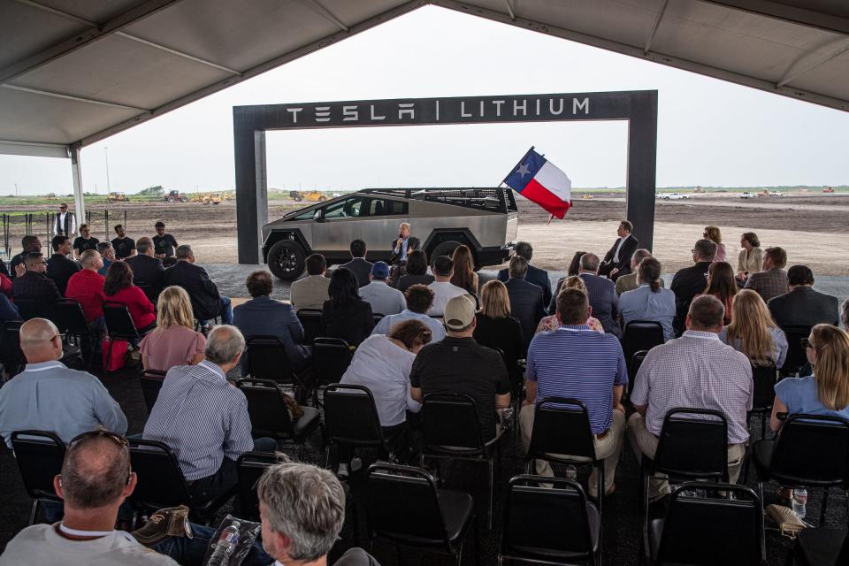 Tesla CEO Elon Musk, right, listens to Texas Gov. Greg Abbott speak to a crowd during a groundbreaking ceremony for the auto manufacturer's preposed lithium refining facility in Robstown, on Monday, May 8, 2023, in Texas.