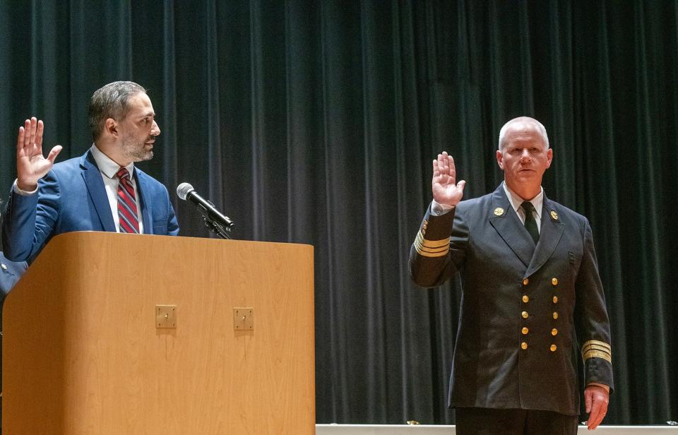 Worcester City Manager Eric D. Batista, left, swears in Martin Dyer as chief of the Worcester Fire Department.