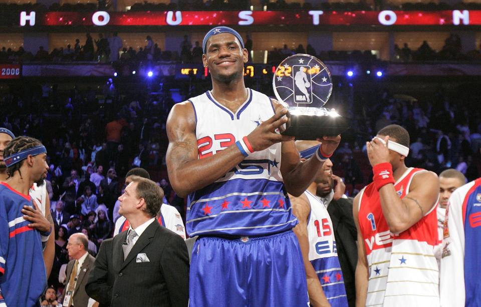 HOUSTON - FEBRUARY 19: 2006 All-Star Game Most Valuable Player LeBron James#23 of the Eastern Conference celebrates with the trophy following the East's 122-120 win over the Western Conference during the 2006 NBA All-Star Game February 19, 2006 at the Toyota Center in Houston, Texas.