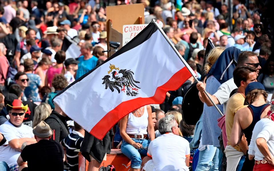 A participant wave a flag of former German Empire  - AFP