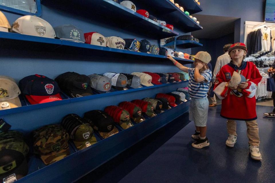 Two young boys try on Panthers hats at the store located in the newly constructed Baptist Health IcePlex in Fort Lauderdale. Jose A. Iglesias/jiglesias@elnuevoherald.com