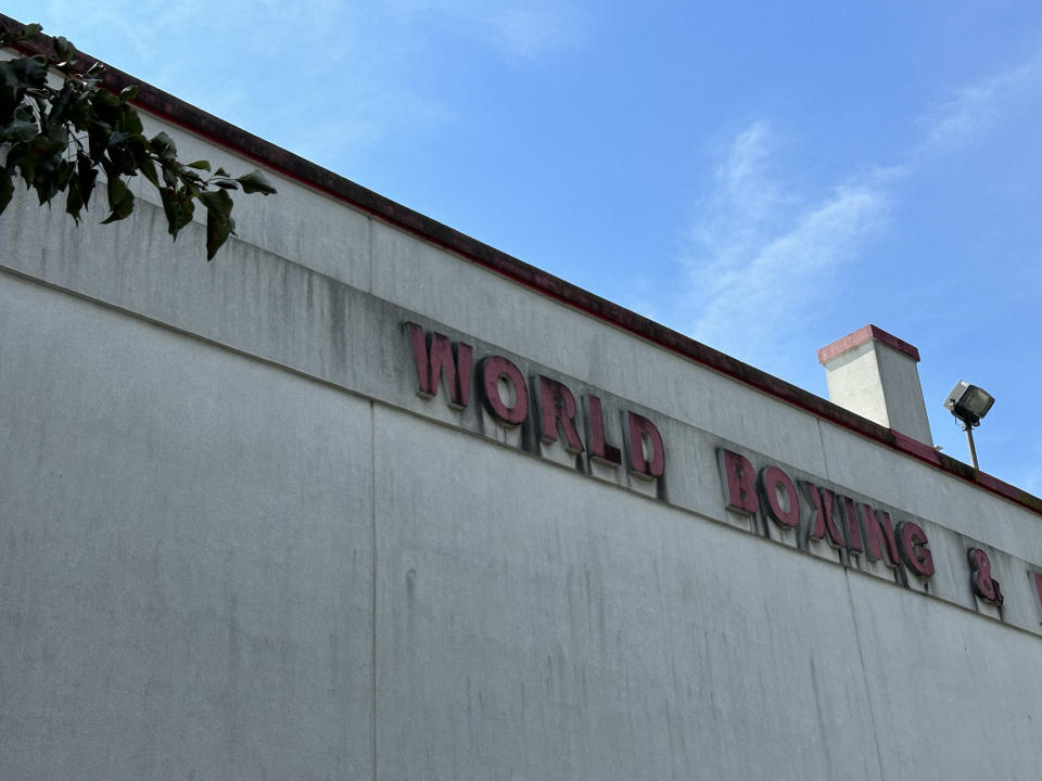 <p>A photo from the iPhone 14 Pro's main camera at 2x zoom featuring an aging sign for a gym against a blue sky.</p>
