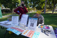 Yes on Measure H! campaign volunteer leader, Liberty McCoy, left, and campaign coordinator director, Bee Rooney gather at La Pintoresca Park to distribute campaign flyers to volunteers in Pasadena, Calif., Saturday, Oct. 29, 2022. Cities across the country are pushing measures to stabilize or control rents when housing prices are skyrocketing. Voters from Orange County, Florida, and in several California cities are asking voters to approve ballot measures that would cap rent increases. (AP Photo/Damian Dovarganes)