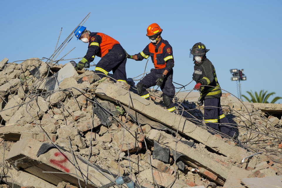 Rescue personnel search the site of a building collapse in George, South Africa, Thursday, May 9, 2024. Rescue teams searching for dozens of construction workers missing after a multi-story apartment complex collapsed in the coastal city have not brought out more survivors in the past 24 hours. (AP Photo/Jerome Delay)