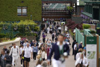 Spectators arrive at the courts on day one of the Wimbledon tennis championships in London, Monday, June 27, 2022. (AP Photo/Alberto Pezzali)