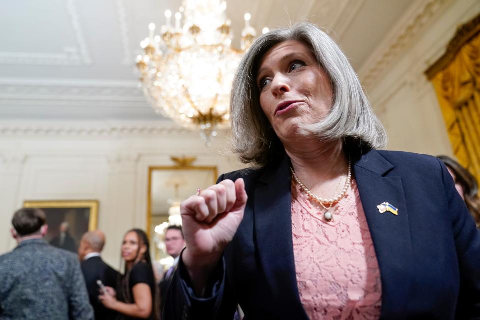 Sen. Joni Ernst, R-Iowa, talks with a reporter after attending an event to celebrate the reauthorization of the Violence Against Women Act in the East Room of the White House, Wednesday, March 16, 2022, in Washington.