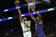 Boston Celtics forward Jayson Tatum drives toward the basket as Charlotte Hornets center Nick Richards defends during the first half of an NBA basketball game, Monday, Nov. 28, 2022, in Boston. (AP Photo/Steven Senne)