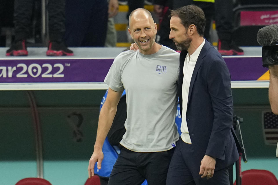 Head coach Gregg Berhalter of the United States and England's head coach Gareth Southgate talk at the end of the World Cup group B soccer match between England and The United States, at the Al Bayt Stadium in Al Khor , Qatar, Friday, Nov. 25, 2022. (AP Photo/Julio Cortez)