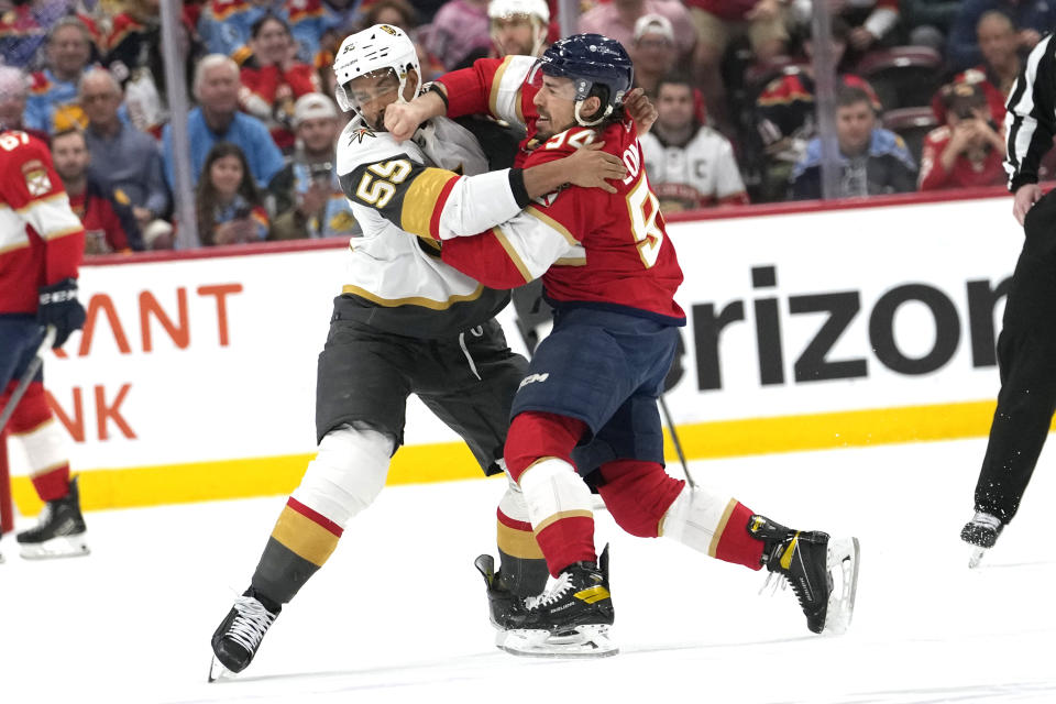 Vegas Golden Knights right wing Keegan Kolesar (55) and Florida Panthers left wing Ryan Lomberg (94) fight during the first period of an NHL hockey game, Saturday, Dec. 23, 2023, in Sunrise, Fla. (AP Photo/Lynne Sladky)