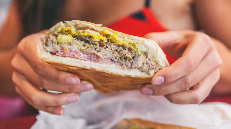 Woman holding Cuban sandwich