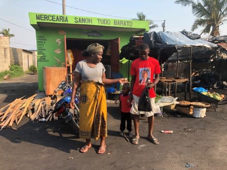 A man wearing a campaign t-shirt for President Filipe Nyusi is seen at a market in Beira