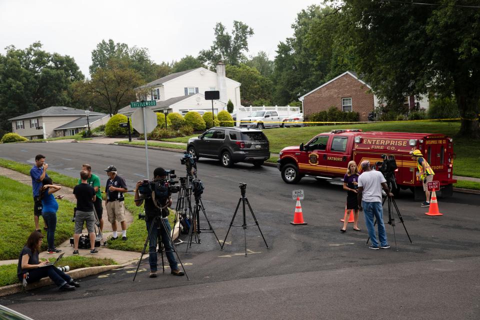 Members of the media gather near the location of a small plane crash in a residential neighborhood in Upper Moreland, Pa., Thursday, Aug. 8, 2019.