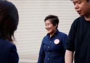 Hiroko Kusaba, CEO of Seiko SCM, laughs as she talks to acquaintances at her factory in Higashiosaka