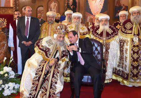 Egyptian Coptic Pope Tawadros II (L), Pope of the Coptic Orthodox Church of Alexandria and Patriarch of Saint Marc Episcopate receives Egyptian President Abdel Fattah al-Sisi (R), at the new Coptic Cathedral at the new Coptic Cathedral "The Nativity of Christ" in the new administrative capital, 45 km east of Cairo, Egypt January 6, 2018, in this handout picture courtesy of the Egyptian Presidency. The Egyptian Presidency/Handout via REUTERS