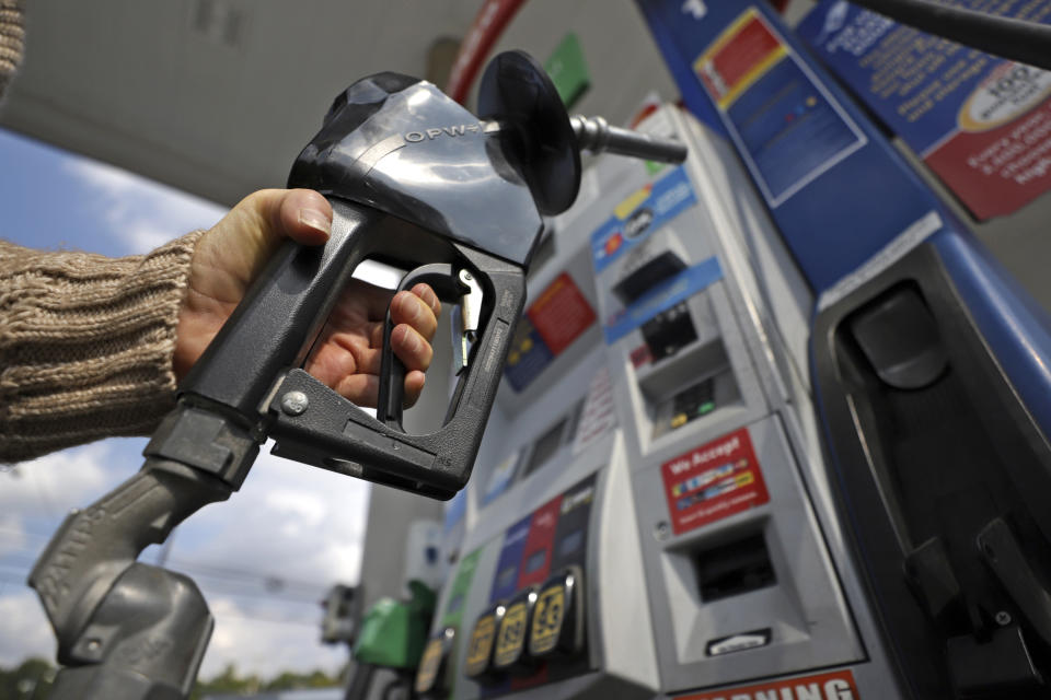 A woman pumps gas at a gas pump at a convenience store in Pittsburgh Monday, Sept. 16, 2019. (AP Photo/Gene J. Puskar)