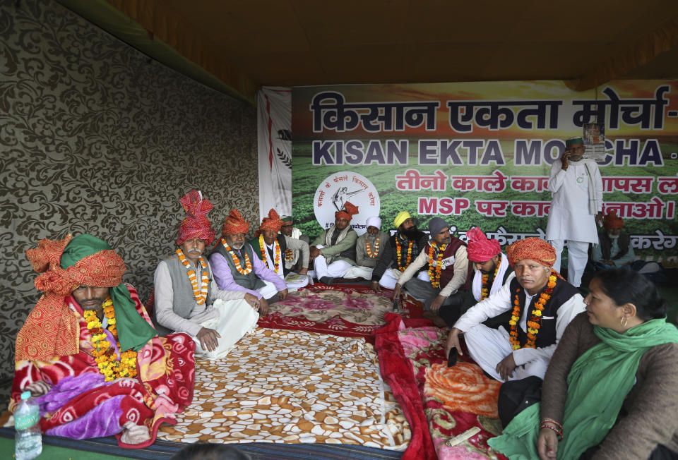 Farmers participate in a day-long hunger strike to protest against new farm laws, at the Delhi-Uttar Pradesh border, on the outskirts of New Delhi, India, Saturday, Jan. 30, 2021. Indian farmers and their leaders spearheading more than two months of protests against new agriculture laws began a daylong hunger strike Saturday, directing their fury toward Prime Minister Narendra Modi and his government. Farmer leaders said the hunger strike, which coincides with the death anniversary of Indian independence leader Mahatma Gandhi, would reaffirm the peaceful nature of the protests. (AP Photo/Manish Swarup)