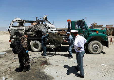 Afghan security forces inspect at the site of a suicide attack in west of Kabul, Afghanistan May 25, 2016. REUTERS/Mohammad Ismail