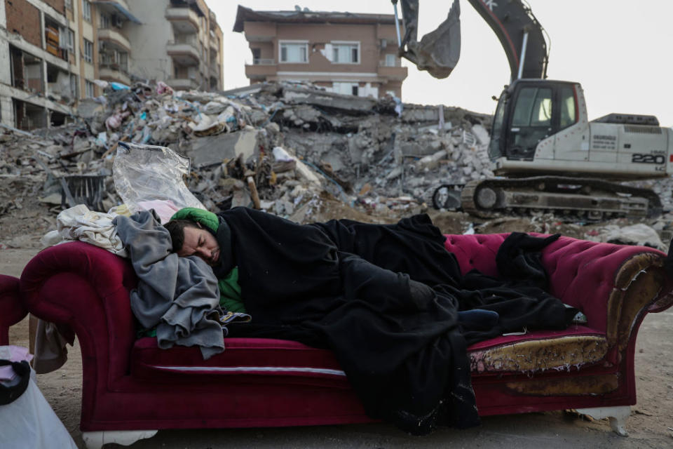 People outside in the wreckage of an earthquake