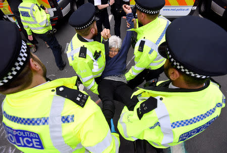 Members of the police carry a demonstrator during the Extinction Rebellion protest at the Marble Arch in London, Britain April 24, 2019. REUTERS/Toby Melville