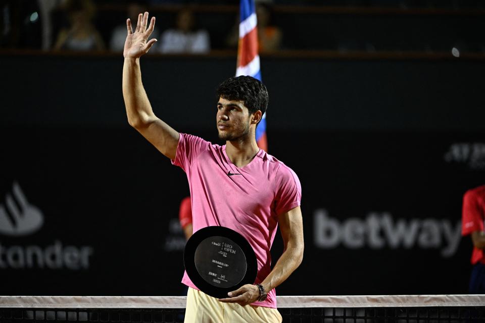 Carlos Alcaraz (pictured) waves to the crowd.