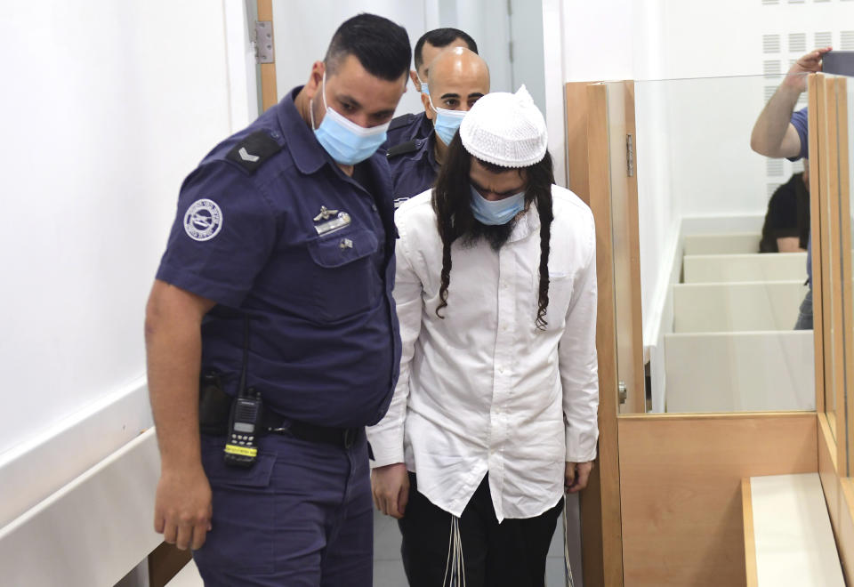 Israeli right-wing activist Amiram Ben-Uliel arrives at a district court for a verdict in the city of Lod, Israel, Monday, May 18, 2020. An Israeli district court has convicted Ben-Uliel of murder in a 2015 arson attack that killed a Palestinian toddler and his parents. (Avshalom Sassoni/Pool Photo via AP)