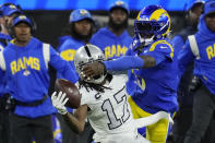 Las Vegas Raiders wide receiver Davante Adams (17) makes a one-handed catch as Los Angeles Rams cornerback Jalen Ramsey defends during the first half of an NFL football game Thursday, Dec. 8, 2022, in Inglewood, Calif. (AP Photo/Marcio Jose Sanchez)