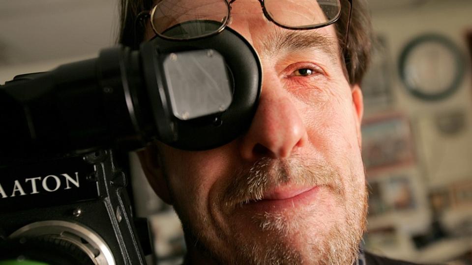 CAMBRIDGE, MA - SEPTEMBER 15: Documentary filmmaker Ross McElwee holding his film camera. He and his film  Bright Leaves is subject of Feeney review. He teaches at Harvard University where he was shot in his office. (Photo by Suzanne Kreiter/The Boston Globe via Getty Images)