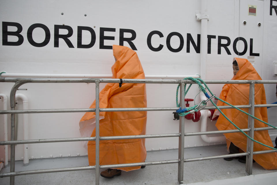 FILE -Two children prepare to disembark with other 53 migrants and refugees from a Norwegian Frontex patrol vessel after they were rescued near the shores of the Greek island of Lesbos, Greece, Tuesday, March 22, 2016. At a summit on Feb. 9-10, 2023, the EU's 27 heads of state and government are set to emphasise the importance of beefing up borders and pressuring the often-impoverished countries that people leave or cross to get to Europe, according to a draft statement prepared for the meeting. (AP Photo/Petros Giannakouris, File)