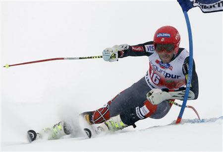 Bode Miller of the U.S. clears a gate during the first run of the men's World Cup giant slalom race in St. Moritz February 2, 2014. REUTERS/Christian Hartmann