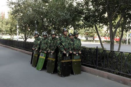 Chinese security forces stand in formation as they secure a street in Urumqi in China's Xinjiang Autonomous Region in this September 6, 2009 file photo. REUTERS/Nir Elias/Files