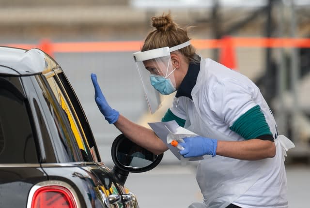 Staff collect samples at a drive through test centre in Leicester (Joe Giddens/PA)