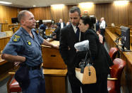Oscar Pistorius, hugs his sister Aimee, right, inside court at the end of the second day of his trial at the high court in Pretoria, South Africa, Tuesday, March 4, 2014. Pistorius is charged with murder for the shooting death of his girlfriend, Reeva Steenkamp, on Valentines Day in 2013. (AP Photo/Antoine de Ras, Pool)
