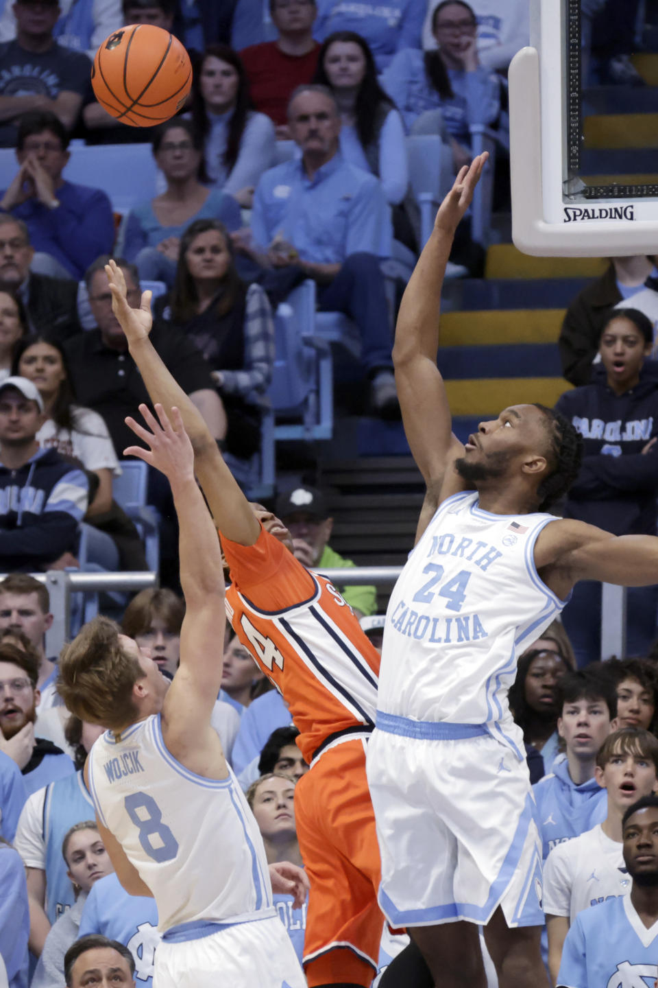 North Carolina guard Paxson Wojcik (8) and forward Jae'Lyn Withers (24) defend against Syracuse guard Quadir Copeland, center, during the first half of an NCAA college basketball game Saturday, Jan. 13, 2024, in Chapel Hill, N.C. (AP Photo/Chris Seward)