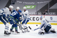 Vancouver Canucks center Jay Beagle (83) tries to get a shot past Toronto Maple Leafs goaltender Michael Hutchinson (30) during the second period of an NHL hockey game Thursday, March 4, 2021, in Vancouver, British Columbia. (Jonathan Hayward/The Canadian Press via AP)