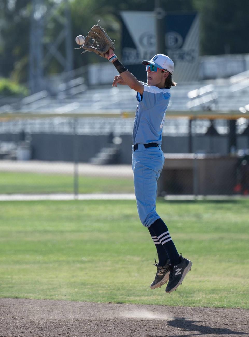 Oakmont second baseman Trevor Wilson snares a high bouncer during the Northern California Regional Division III championship game with Central Catholic at Central Catholic High School in Modesto, Calif., Saturday, June 3, 2023.