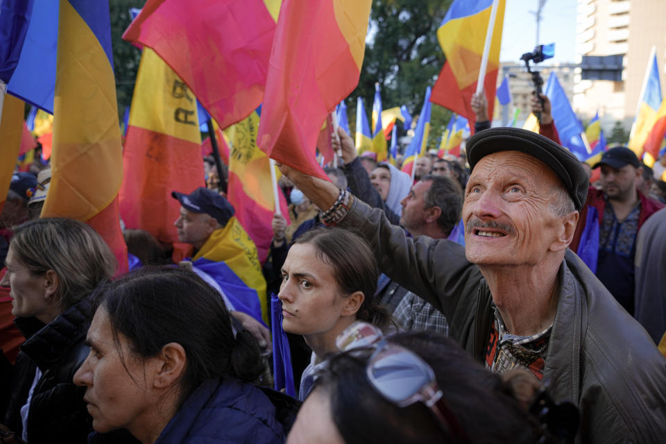 People wave flags during an anti-government protest organised by the far-right Alliance for the Unity of Romanians or AUR, in Bucharest, Romania, Saturday, Oct. 2, 2021. Thousands took to the streets calling for the governments resignation, as Romania reported 12.590 new COVID-19 infections in the past 24 hour interval, the highest ever daily number since the start of the pandemic. (AP Photo/Vadim Ghirda)