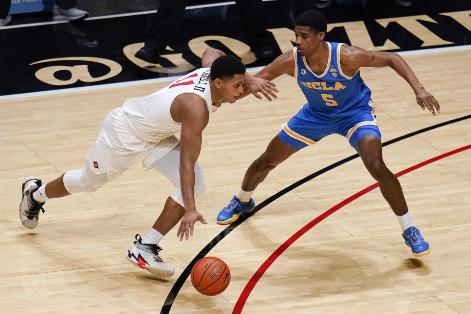 San Diego State forward Matt Mitchell, right, drives to the basket as UCLA guard Chris Smith (5) defends during the first half of an NCAA college basketball game Wednesday, Nov. 25, 2020, in San Diego. (AP Photo/Gregory Bull)