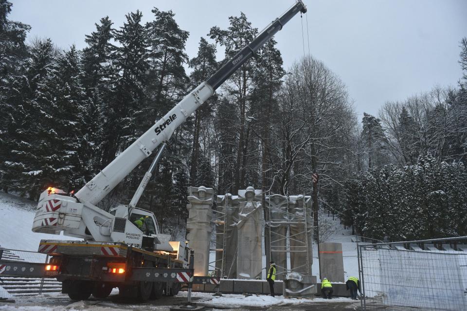 FILE - Municipal workers dismantle the memorial of the Red Army Soldiers who died during the liberation of Vilnius from Nazi invaders during WWII at the Antakalnis Memorial Cemetery in Vilnius, Lithuania, Wednesday, Dec. 7, 2022. Estonia and other NATO members - Latvia and Lithuania - have sought to remove the monuments widely seen as a legacy of Soviet occupation of the countries. Moscow has denounced those moves as a desecration of memory of Soviet soldiers who fell while fighting the Nazis. (AP Photo, File)