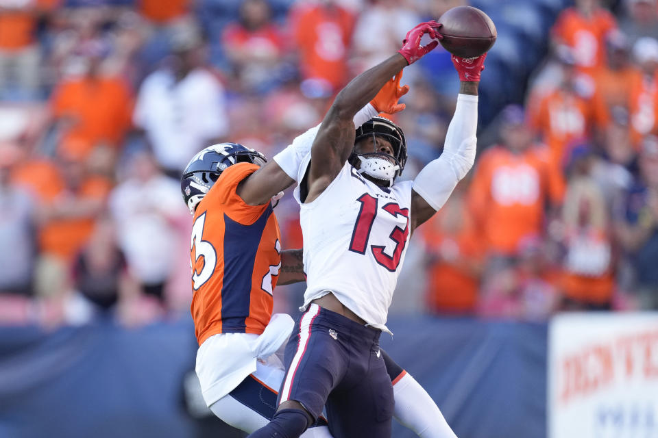 FILE - Houston Texans wide receiver Brandin Cooks (13) makes a catch as Denver Broncos cornerback Ronald Darby defends during the second half of an NFL football game on Sept. 18, 2022, in Denver. The Dallas Cowboys acquired receiver Cooks in a trade with the Houston Texans on Sunday, March 19, 2023, adding a speedy veteran to play alongside CeeDee Lamb. (AP Photo/David Zalubowski, File)