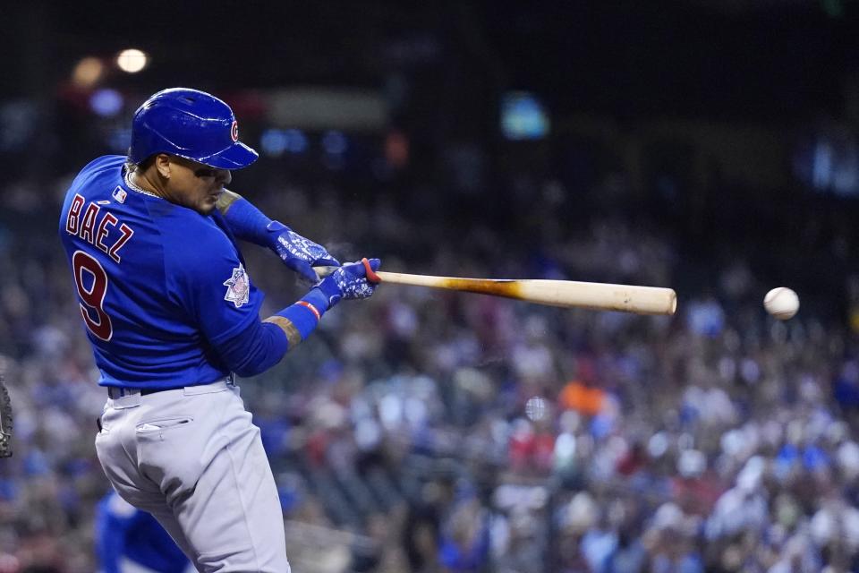 Chicago Cubs' Javier Baez connects for a run-scoring single against the Arizona Diamondbacks during the sixth inning of a baseball game, Sunday, July 18, 2021, in Phoenix. (AP Photo/Ross D. Franklin)