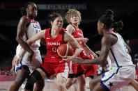 Japan's Moeko Nagaoka (0), second left, drives past United States' Tina Charles (14), left, during women's basketball preliminary round game at the 2020 Summer Olympics, Friday, July 30, 2021, in Saitama, Japan. (AP Photo/Charlie Neibergall)