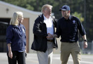President Donald Trump shakes hands with FEMA Administrator Brock Long as Homeland Security Secretary Kirstjen Nielsen watches after visiting areas in North Carolina and South Carolina impacted by Hurricane Florence, Wednesday, Sept. 19, 2018, at Myrtle Beach International Airport in Myrtle Beach, S.C. (AP Photo/Evan Vucci)