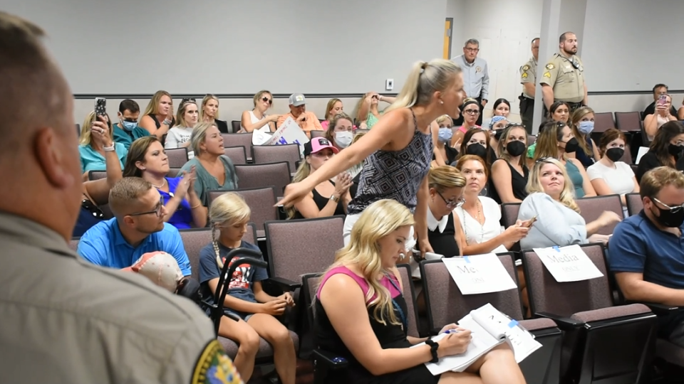 An anti-mask mother of a special needs student shouts at board member Jen Aprea — a fellow mother of a special needs student — as Aprea speaks on the importance of masks in protecting high-risk students.