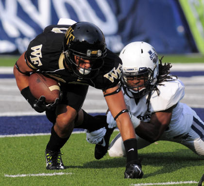 Utah State running back Kennedy Williams tackles Wake Forest wide receiver Jared Crump as he returns a punt during an NCAA football game, Saturday, Sept. 13, 2014, in Logan, Utah. (AP Photo/Eli Lucero)