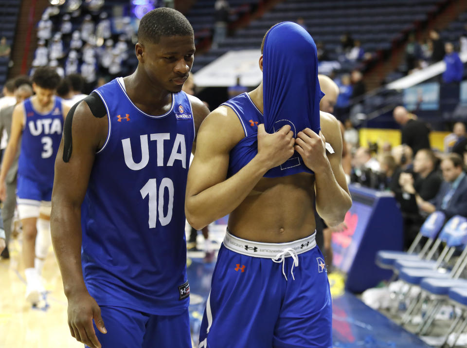 Texas-Arlington guard Radshad Davis (10) and guard Edric Dennis (5) walk off the court after the NCAA college basketball championship game of the Sun Belt Conference men's tournament in New Orleans, Sunday, March 17, 2019. (AP Photo/Tyler Kaufman)