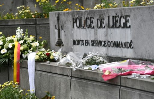 A picture taken on May 30, 2018 shows flowers that are laid in front of Liege police headquarters in tribute to victims of a shooting in Liege