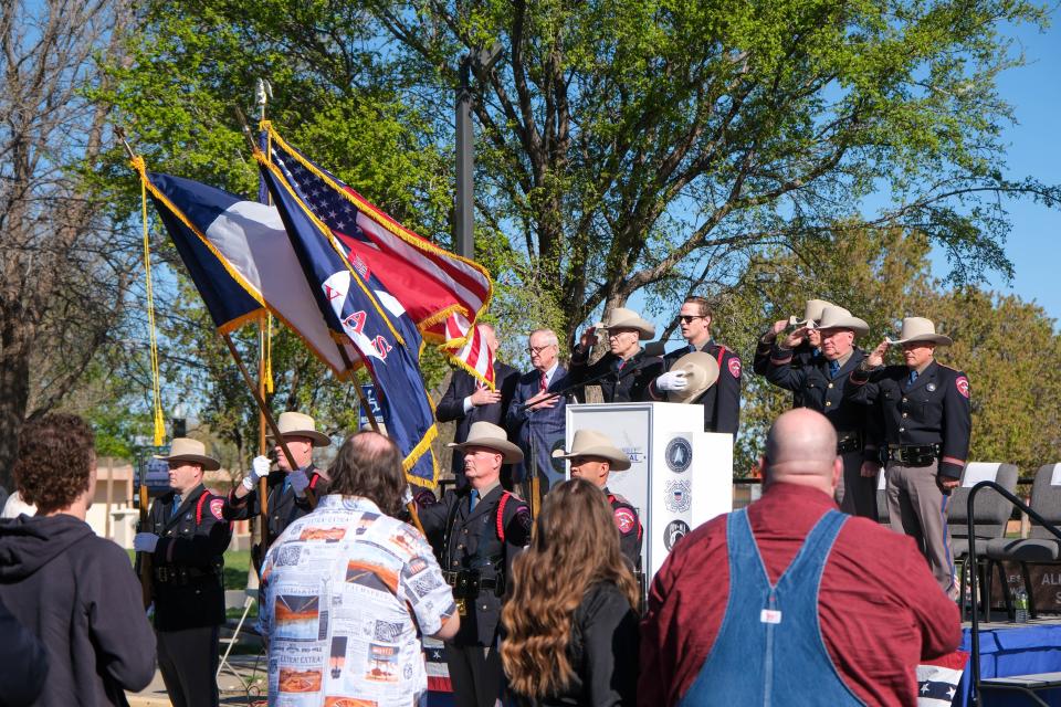 Family and troopers stand at a dedication of a boat named for fallen State Trooper Steve Booth at a ceremony Thursday held at the Texas Panhandle War Memorial Center in Amarillo.