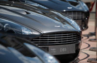 <p><b>Aston Martin</b></p> <p>You might have seen James Bond driving the iconic Aston Martin luxury car. But do you know who owns the vehicle-manufacturing company? In 2007, Aston Martin was purchased for £479m ($750m) by a joint venture company, headed by David Richards, John Singers, an American investment banker; and two Kuwaiti investment companies, Investment Dar and Adeem Investment.</p> (Photo by Matt Cardy/Getty Images)